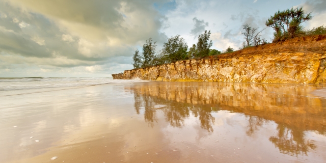 Cliffs reflecting in wet sand at Casuarina Beach, taken with a polariser filter